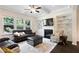 Inviting living room features a ceiling fan, a fireplace with built-in bookshelves, and large windows at 2289 Emerald Sky Dr, Smyrna, GA 30080