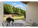 Charming outdoor patio with dining set and grill, offering a relaxing space amidst lush greenery at 2289 Emerald Sky Dr, Smyrna, GA 30080