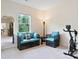 Sitting area with furniture, exercise equipment, and a view of the outside greenery at 2289 Emerald Sky Dr, Smyrna, GA 30080