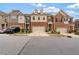 Attractive townhomes with brick and neutral siding, driveways, and well-maintained landscaping at 2289 Emerald Sky Dr, Smyrna, GA 30080