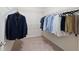Walk-in closet with ample space to hang shirts, pants, and a suit at 2289 Emerald Sky Dr, Smyrna, GA 30080