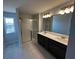 Bathroom with double vanity, glass shower, large window, and elegant tile flooring at 258 Depot Landing Rd # 53, Auburn, GA 30011