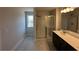 Modern bathroom featuring a glass enclosed shower, single sink, and large mirror at 258 Depot Landing Rd # 53, Auburn, GA 30011