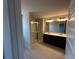 Bathroom featuring dual sink vanity, tiled floor, and a glass-enclosed shower stall at 258 Depot Landing Rd # 53, Auburn, GA 30011