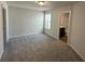 Bedroom with neutral carpeting and window; ensuite bathroom can be seen through the doorway at 258 Depot Landing Rd # 53, Auburn, GA 30011
