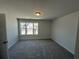Carpeted bedroom with a window and neutral paint at 258 Depot Landing Rd # 53, Auburn, GA 30011