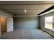 Bedroom features modern grey wall design, carpet flooring, and a bright window for natural light at 258 Depot Landing Rd # 53, Auburn, GA 30011