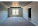Spacious bedroom with grey color palette, carpet flooring, and large window providing natural light at 258 Depot Landing Rd # 53, Auburn, GA 30011