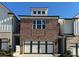 Charming brick townhome with a two-car garage and white trim details at 258 Depot Landing Rd # 53, Auburn, GA 30011