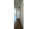 Hallway featuring hardwood floors and modern paneled door at 258 Depot Landing Rd # 53, Auburn, GA 30011