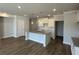 Spacious kitchen with white cabinets, granite countertops and hardwood floors at 258 Depot Landing Rd # 53, Auburn, GA 30011