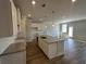 Bright, open-concept kitchen with a center island and stainless steel sink at 258 Depot Landing Rd # 53, Auburn, GA 30011