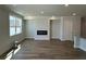 Open-concept living room featuring a modern fireplace and hardwood floors at 258 Depot Landing Rd # 53, Auburn, GA 30011