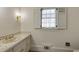 Bright bathroom with a sink, a window with shutters, and neutral wall paint at 270 Grapevine Run, Sandy Springs, GA 30350