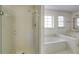 Modern bathroom featuring tiled walls and a glass enclosed shower at 270 Grapevine Run, Sandy Springs, GA 30350