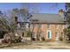 Charming brick two-story home with a well-manicured lawn, and a colorful front door at 270 Grapevine Run, Sandy Springs, GA 30350