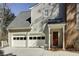 Attached two car garage of home with white doors and a red front door at 270 Grapevine Run, Sandy Springs, GA 30350