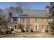 Charming brick two-story home with a well-manicured lawn, and a colorful front door at 270 Grapevine Run, Sandy Springs, GA 30350