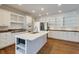 Contemporary white kitchen featuring stainless steel appliances and a kitchen island with seating at 270 Grapevine Run, Sandy Springs, GA 30350