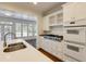 Bright kitchen featuring white cabinets, stainless steel appliances, and an island with quartz countertop at 270 Grapevine Run, Sandy Springs, GA 30350