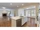 Open-concept kitchen with white cabinets, island, stainless steel dishwasher, and hardwood floors throughout at 270 Grapevine Run, Sandy Springs, GA 30350
