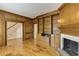 Cozy living room featuring a fireplace, hardwood floors, built-in shelves, and access to the staircase at 270 Grapevine Run, Sandy Springs, GA 30350