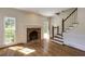 Living room featuring hardwood floors, fireplace, and staircase with wood banister at 270 Grapevine Run, Sandy Springs, GA 30350