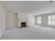 Open living area with fireplace, carpeted floors, and plenty of natural light at 270 Grapevine Run, Sandy Springs, GA 30350