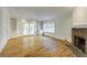Spacious living room features hardwood floors, a fireplace, and french doors leading to an outdoor space at 270 Grapevine Run, Sandy Springs, GA 30350