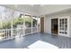 Enclosed porch with gray painted floorboards, and a view into the house through glass doors at 270 Grapevine Run, Sandy Springs, GA 30350