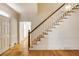 Entryway features hardwood floors, staircase with a white banister, and ample natural light at 270 Grapevine Run, Sandy Springs, GA 30350