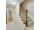 Carpeted staircase with white risers and a wooden handrail leads to the upper floor at 270 Grapevine Run, Sandy Springs, GA 30350