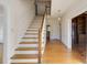 Bright entryway featuring wood floors, a staircase with white risers, and paneled walls at 270 Grapevine Run, Sandy Springs, GA 30350