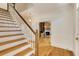 Staircase with hardwood floors and white trim, leading to an open living area at 270 Grapevine Run, Sandy Springs, GA 30350