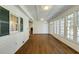 Sunroom with white paneling, hardwood floors, windows, and natural light at 270 Grapevine Run, Sandy Springs, GA 30350