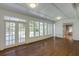 Sunroom featuring hardwood floors, multiple windows, and natural light at 270 Grapevine Run, Sandy Springs, GA 30350