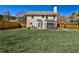 Large fenced backyard with a well-maintained lawn, patio, and seating areas at 705 Chanson Sw Dr, Marietta, GA 30064