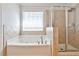 Bathroom boasts a soaking tub with tile surround and glass enclosed shower at 705 Chanson Sw Dr, Marietta, GA 30064