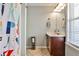 Cozy bathroom featuring a shower/tub combo and single sink vanity with cabinet at 705 Chanson Sw Dr, Marietta, GA 30064