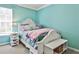 Charming bedroom with aqua walls, carpet, a whimsical decor, and a window to let in natural light at 705 Chanson Sw Dr, Marietta, GA 30064