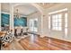 Bright dining room boasts hardwood floors, modern chandelier, and stylish blue accent wall, perfect for entertaining guests at 705 Chanson Sw Dr, Marietta, GA 30064