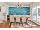 Dining room featuring a modern chandelier, stylish accent wall, and plenty of natural light at 705 Chanson Sw Dr, Marietta, GA 30064