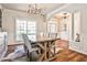 Elegant dining room with hardwood floors, white trim, statement chandelier, and archway offering an open and inviting space at 705 Chanson Sw Dr, Marietta, GA 30064