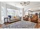 Bright living room featuring a large window, modern lighting, and comfortable seating, creating an inviting atmosphere at 705 Chanson Sw Dr, Marietta, GA 30064