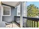 This cozy balcony features wood floors, dark railings, and a view of greenery at 1575 Ridenour Nw Pkwy # 1119, Kennesaw, GA 30152