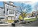 View of condo building with manicured landscaping, stone accents, and a parking space in front at 1575 Ridenour Nw Pkwy # 1119, Kennesaw, GA 30152