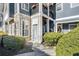 Close-up of condo entrances with stone accents, unit numbers, and well-maintained landscaping at 1575 Ridenour Nw Pkwy # 1119, Kennesaw, GA 30152