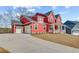 Beautiful two-story red home with a two-car garage and inviting front porch at 4039 Andover Cir, Mcdonough, GA 30252