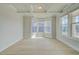 Airy living room with tray ceilings, neutral paint, and sun-filled bay windows at 4039 Andover Cir, Mcdonough, GA 30252