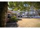 Spacious backyard showcasing a well-maintained lawn, mature trees, and a view of neighboring houses at 520 Camp Perrin Rd, Lawrenceville, GA 30043